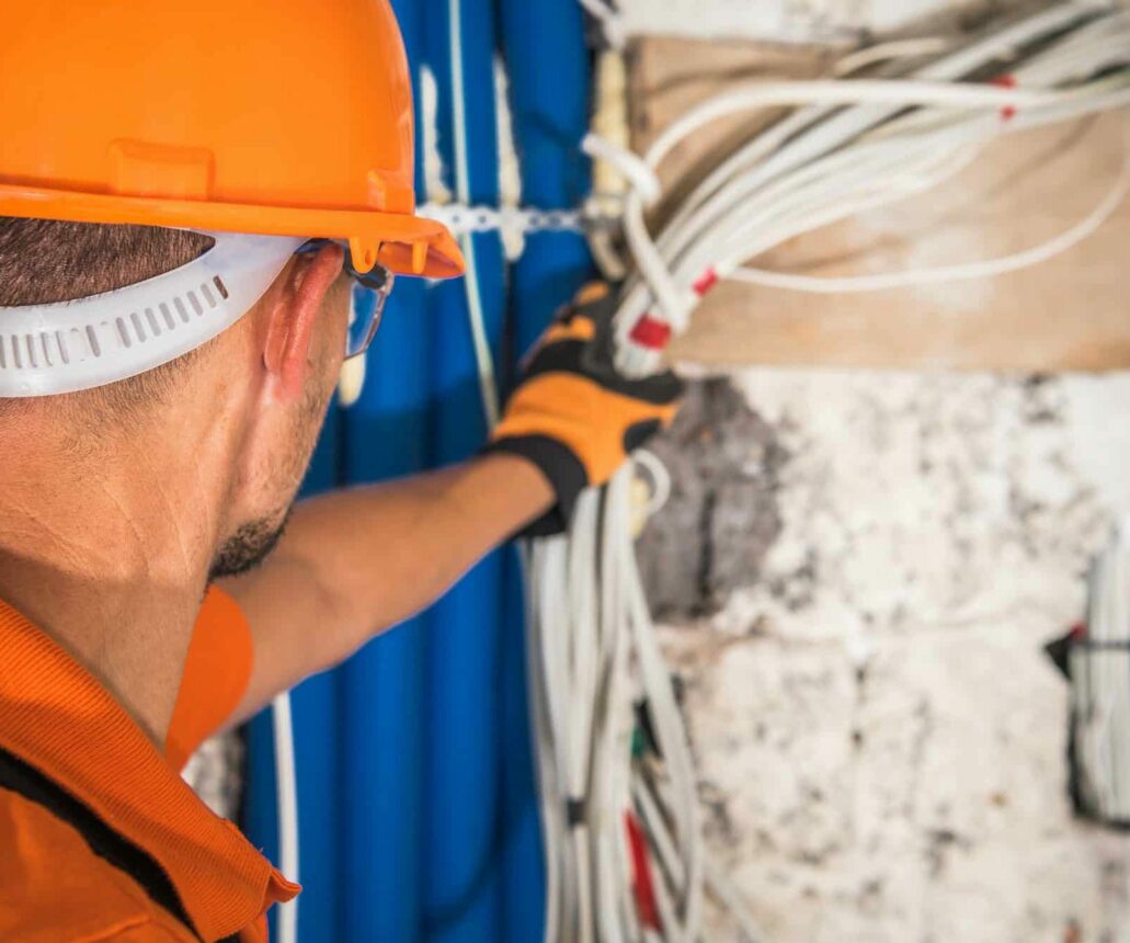 Construction Contractor Looking Inside Electrical Installation