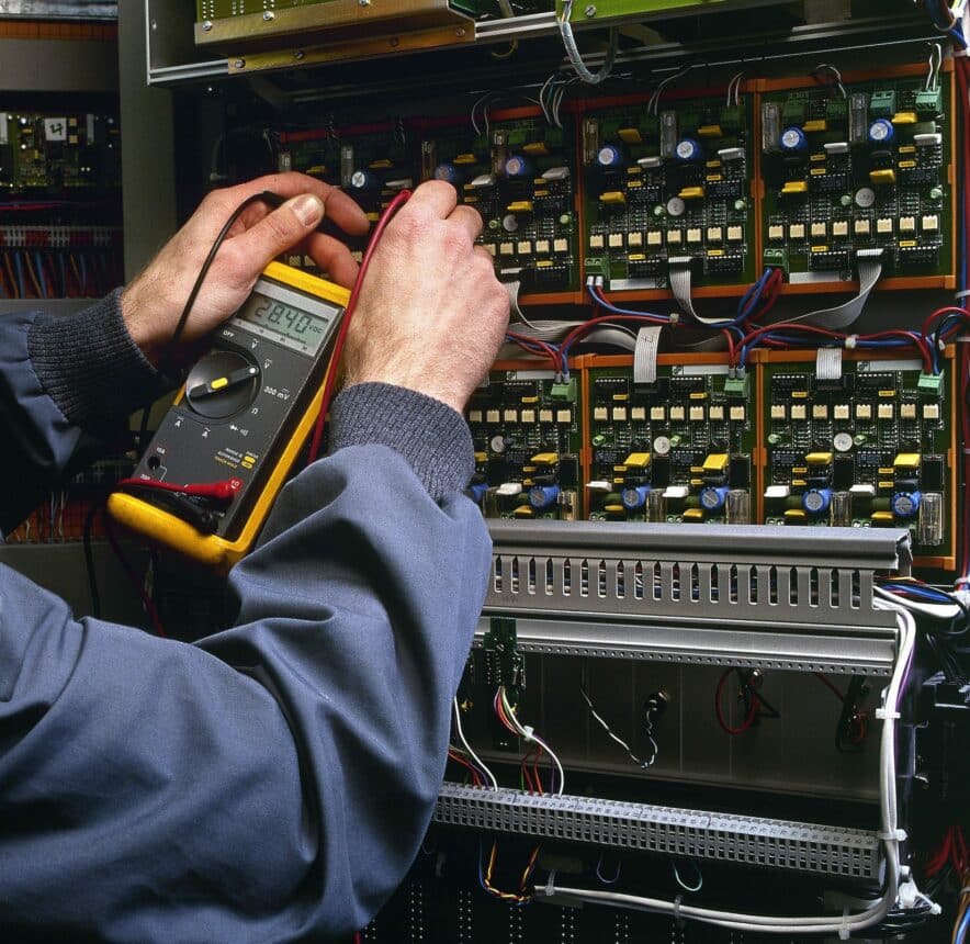 electrician testing industrial machine