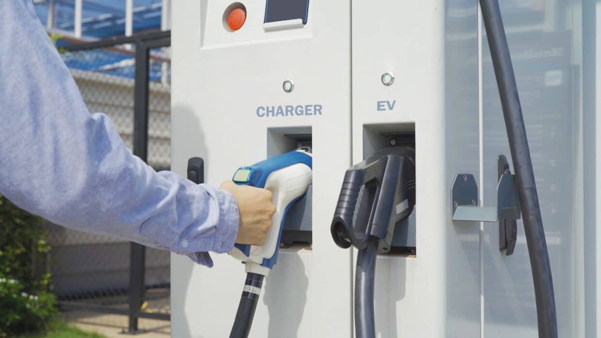 EV car charger or electric vehicle. Power supply battery charging in technology energy innovation