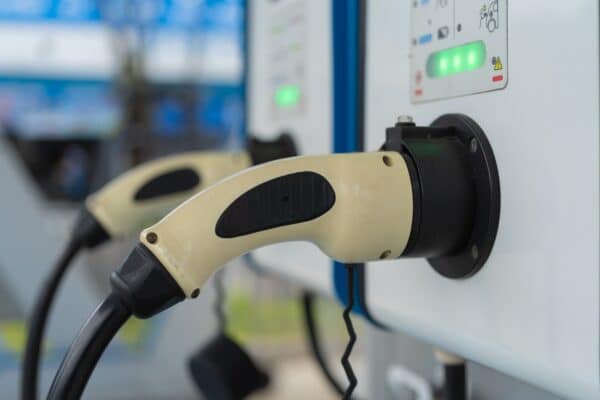 EV car charger or electric vehicle. Power supply battery charging in technology energy innovation