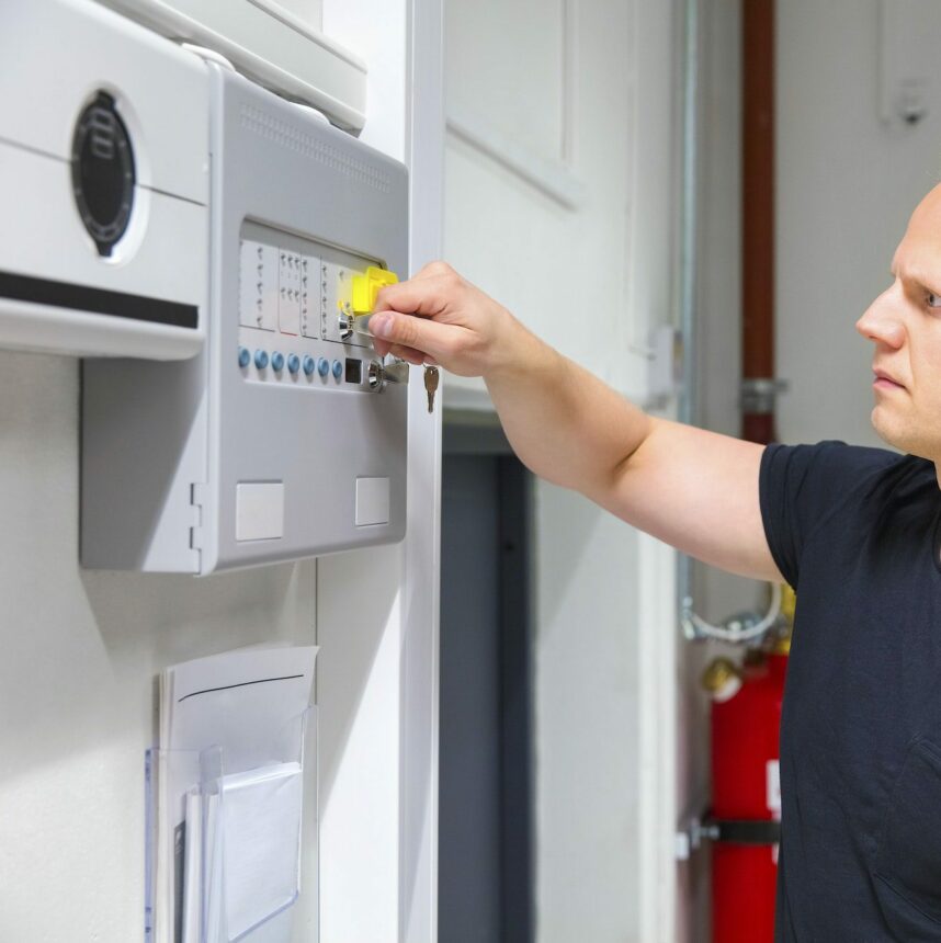 IT Technician Opening Fire Panel In Server Room