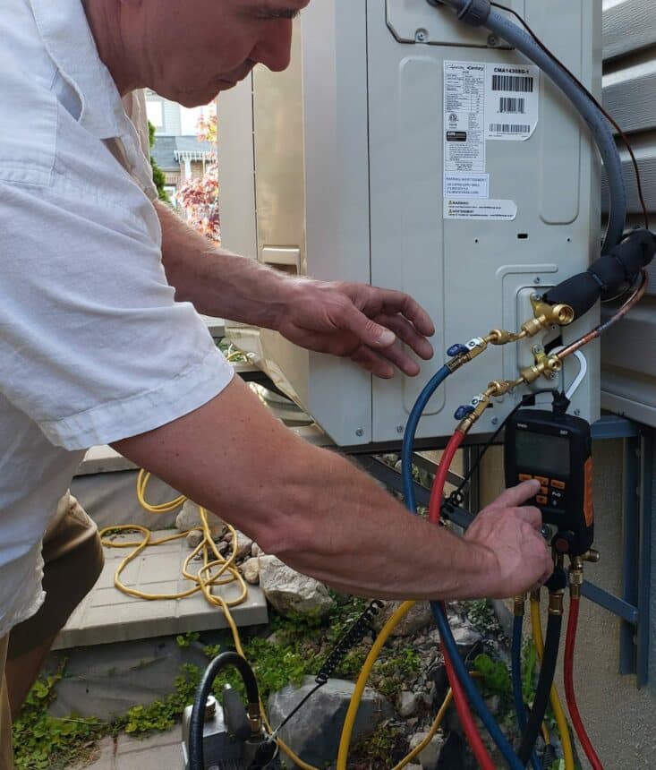 Man is checking proper functionality of electric equipment by measuring electrical current