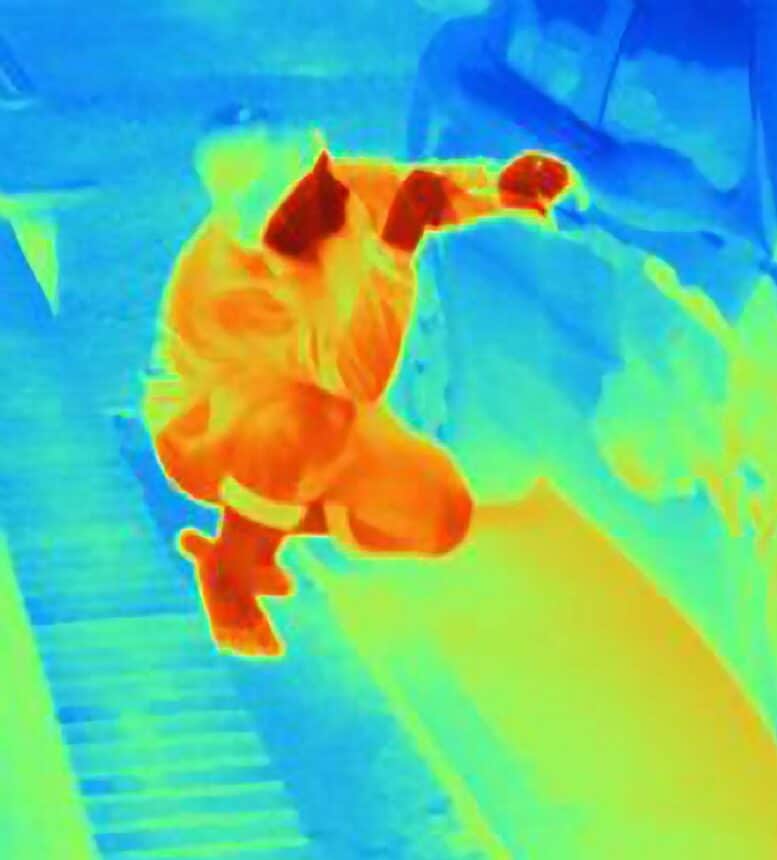 Thermal photograph of a burglar breaking into a car