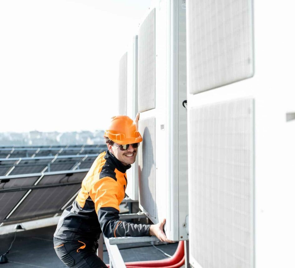 Workman installing outdoor unit of the air conditioner