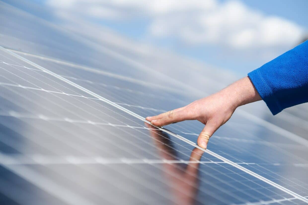 Engineer's hand on solar panel